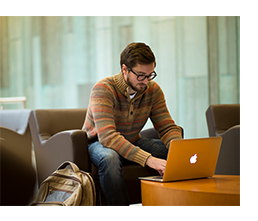 Student on computer in Ridge Commons