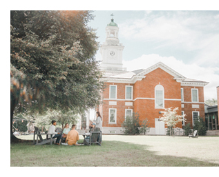 students relaxing outside